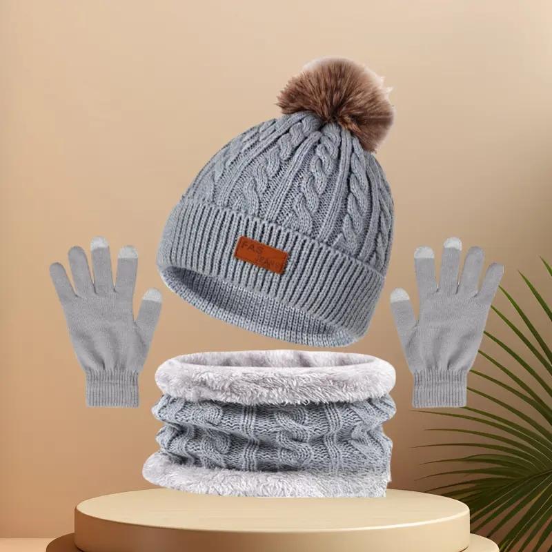 Winter Hats for women Festive winter knitted hat kit featuring pom - poms. This 3 - in - 1 warm set encompasses a thick hat, a cozy scarf, and touchscreen gloves. It's perfect for ladies during cold - day outings.